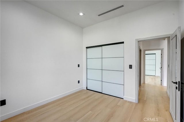 unfurnished bedroom featuring light wood-type flooring