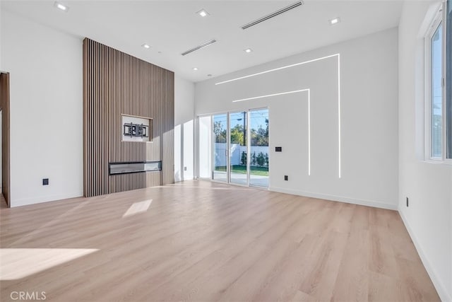 empty room with light hardwood / wood-style flooring