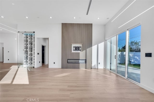 unfurnished living room featuring a healthy amount of sunlight and light wood-type flooring