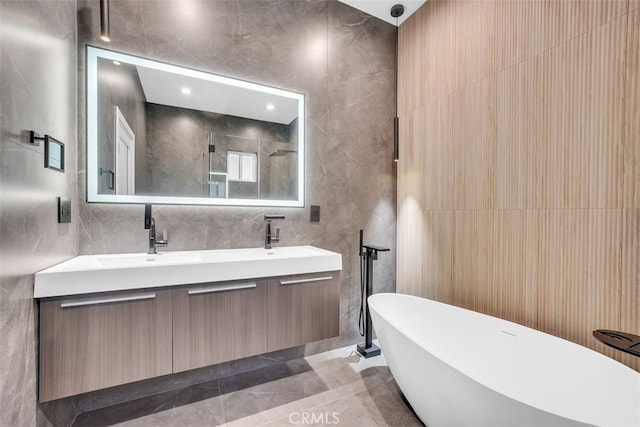 bathroom with vanity, shower with separate bathtub, tile walls, and tile patterned floors