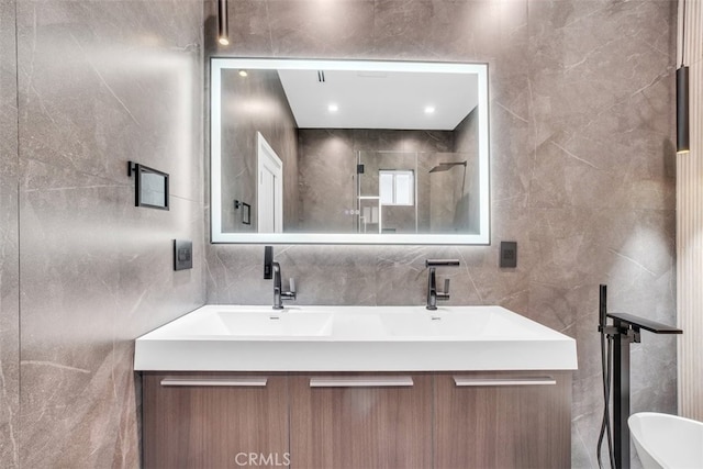 bathroom with vanity and tile walls