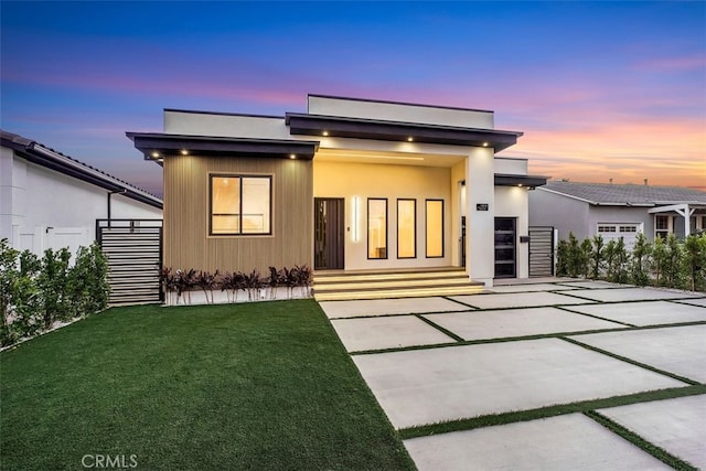 modern home with a patio and a yard