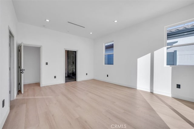 spare room with light wood-type flooring