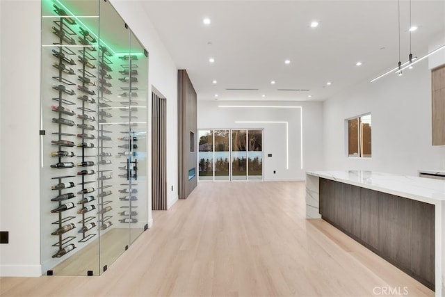 wine cellar featuring light hardwood / wood-style flooring and a wealth of natural light