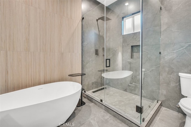 bathroom featuring toilet, shower with separate bathtub, and tile walls