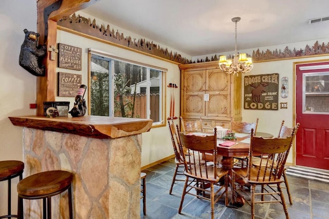 dining space with an inviting chandelier