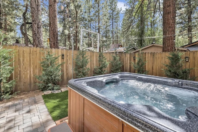 view of swimming pool with a hot tub