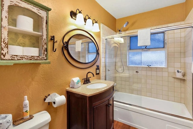 full bathroom with wood-type flooring, vanity, toilet, and enclosed tub / shower combo