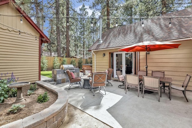 view of patio featuring an outdoor kitchen and a grill