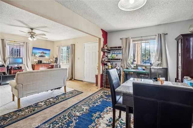 carpeted office with ceiling fan and a textured ceiling