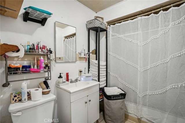 bathroom with tile patterned flooring, toilet, vanity, and walk in shower