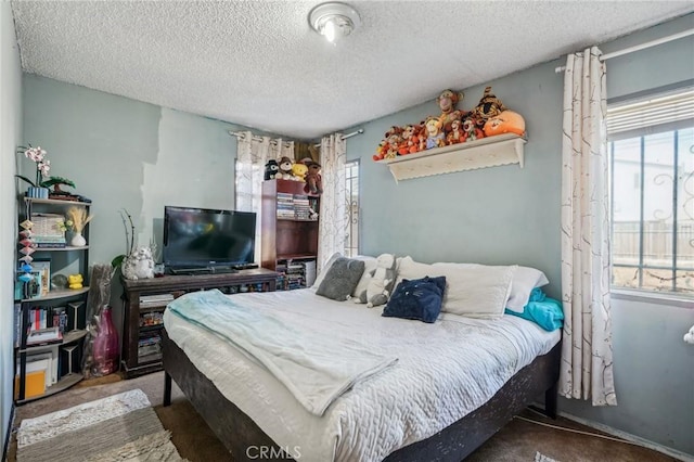 bedroom featuring carpet flooring and a textured ceiling