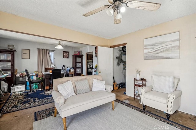 living room with carpet flooring, ceiling fan, and a textured ceiling