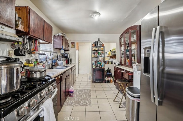 kitchen featuring light tile patterned flooring, sink, and appliances with stainless steel finishes