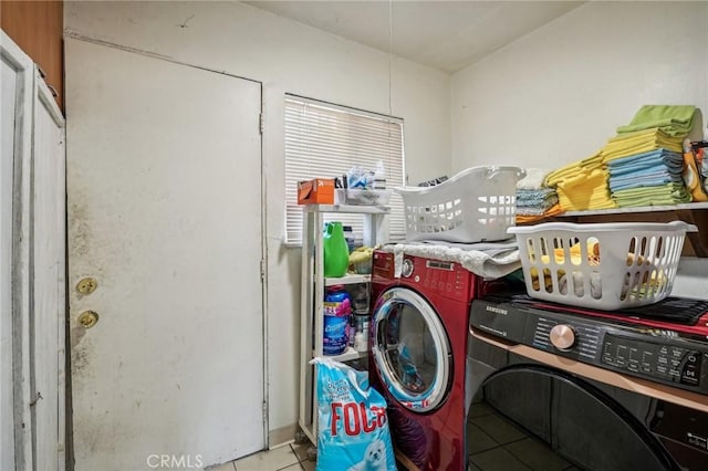 laundry room with separate washer and dryer and light tile patterned floors