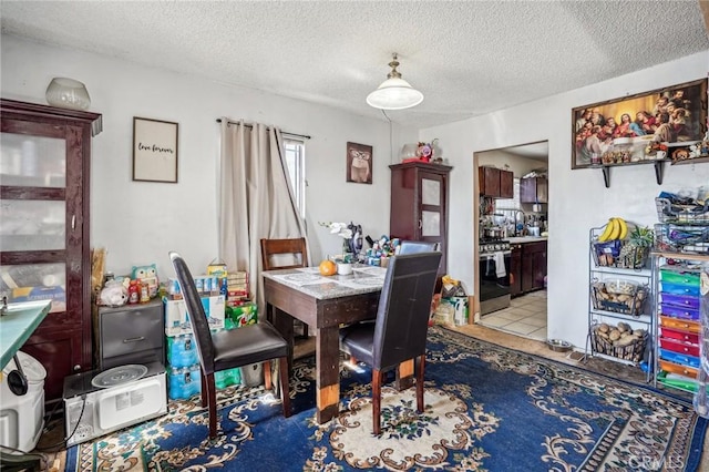 dining room featuring light tile patterned floors and a textured ceiling