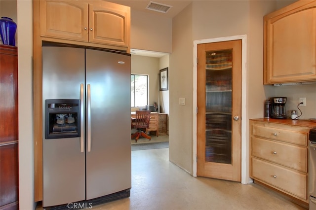 kitchen with appliances with stainless steel finishes and light brown cabinets