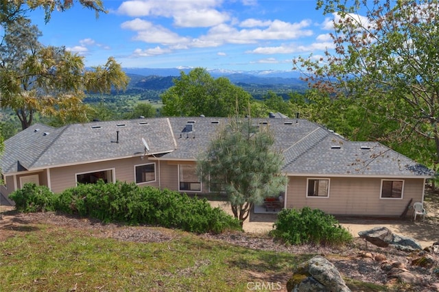 rear view of property featuring a mountain view and a patio