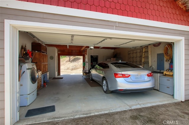 garage with electric panel and a garage door opener