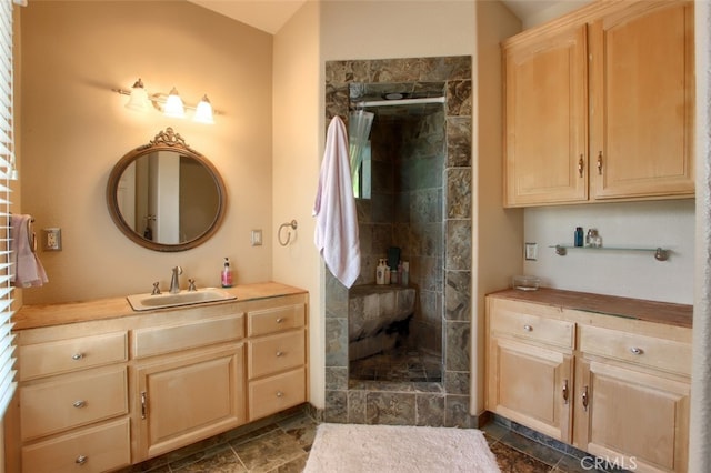 bathroom featuring vanity and a tile shower