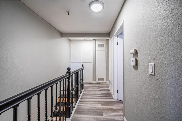 corridor with light hardwood / wood-style flooring