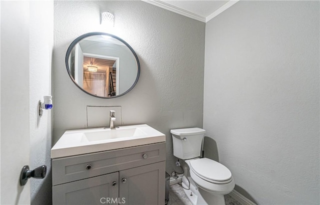 bathroom featuring vanity, toilet, and crown molding