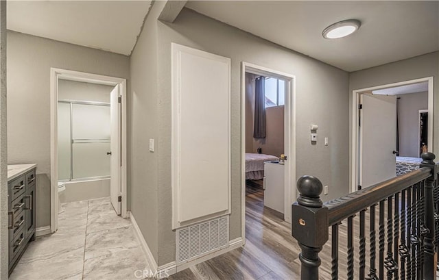 hallway with light hardwood / wood-style floors