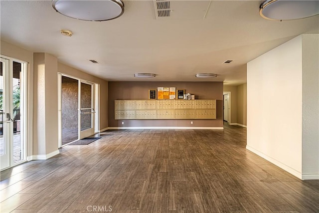 interior space featuring hardwood / wood-style floors, french doors, and a mail area