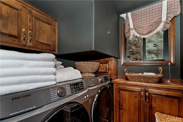 washroom with cabinets and washer and dryer