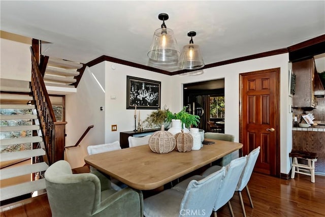 27538 W Shore Rd, Lake Arrowhead, CA 92352 - dining space featuring stairs, dark wood-style flooring, crown molding, and baseboards