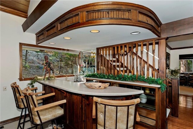 27538 W Shore Rd, Lake Arrowhead, CA 92352 - indoor wet bar featuring wood finished floors, stairs, ornamental molding, and recessed lighting