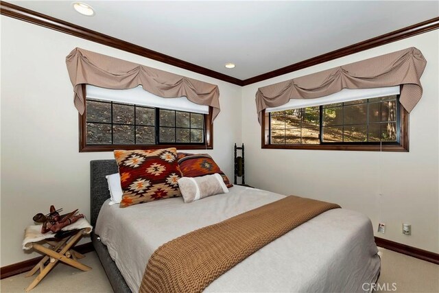 carpeted bedroom with ornamental molding