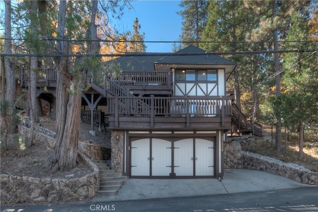 view of front of house featuring a garage and a deck