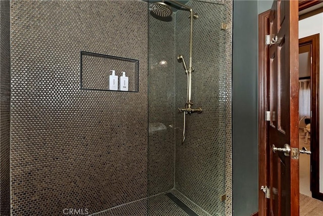 bathroom with a tile shower