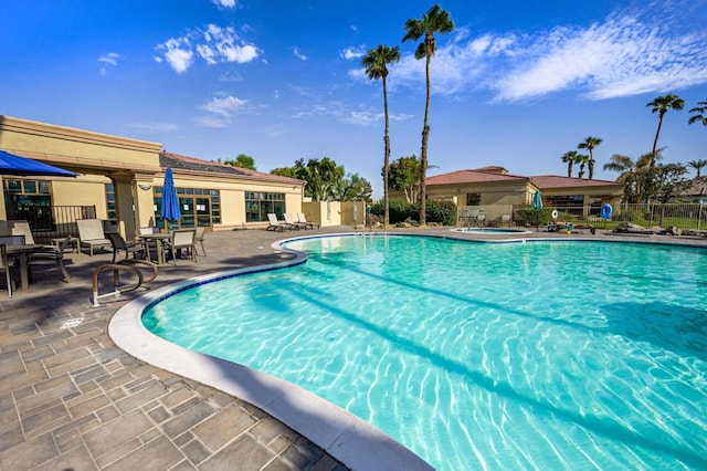 view of swimming pool with a patio area and a hot tub