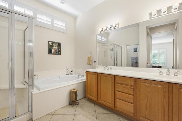 bathroom with tile patterned flooring, vanity, and shower with separate bathtub