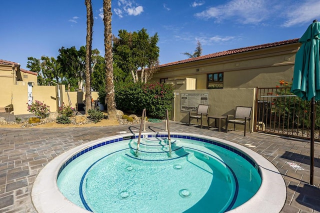 view of pool featuring a patio and a hot tub