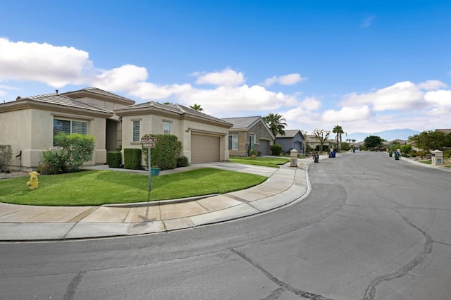 view of front of home featuring a front yard and a garage