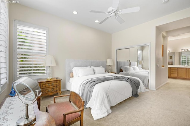 bedroom with light carpet, a closet, and ceiling fan