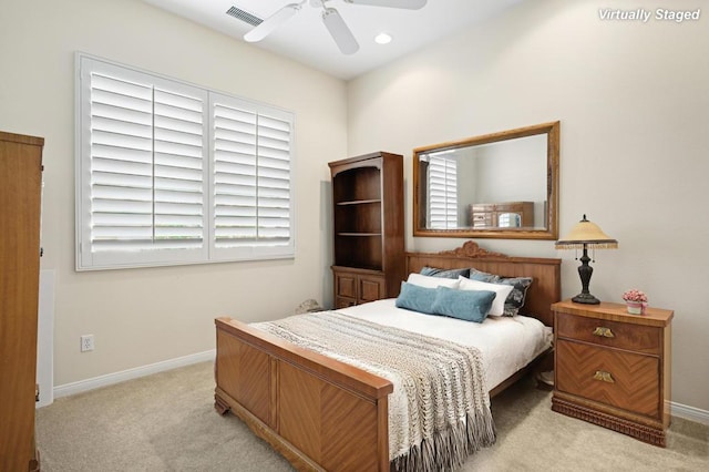 carpeted bedroom with ceiling fan and multiple windows