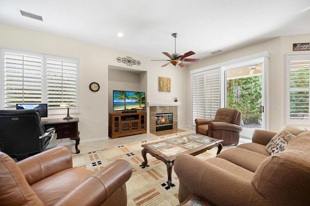 tiled living room with ceiling fan