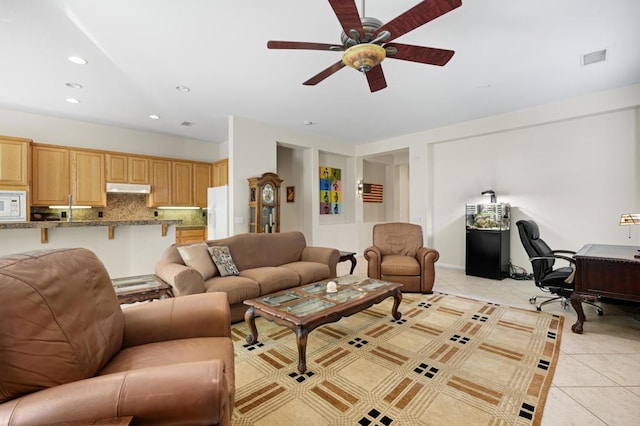 living room featuring ceiling fan and light tile patterned floors