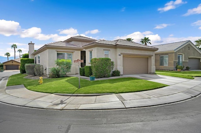 view of front of house with a garage and a front yard