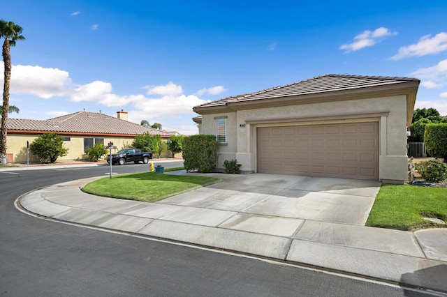 view of front of property featuring a front yard and a garage