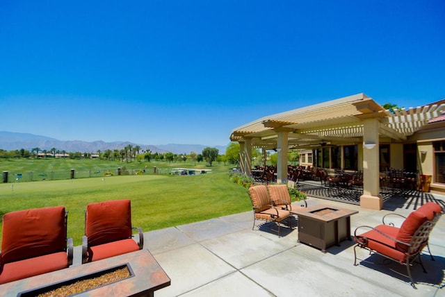 view of patio with a pergola, a mountain view, a rural view, and an outdoor fire pit