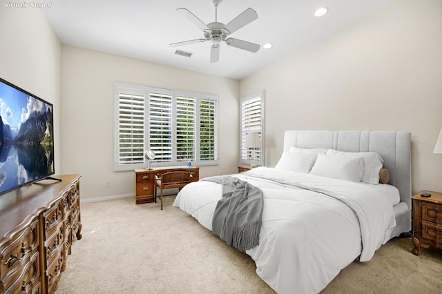 bedroom with ceiling fan and light carpet