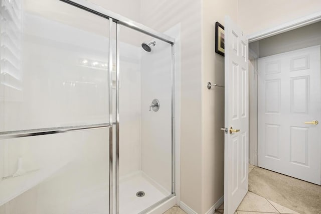 bathroom featuring tile patterned floors and a shower with door