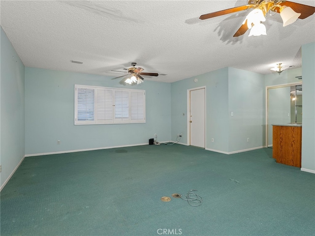 empty room with carpet flooring and a textured ceiling