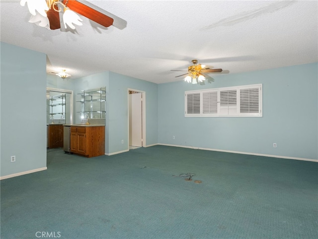 unfurnished living room featuring carpet flooring, ceiling fan, and a textured ceiling