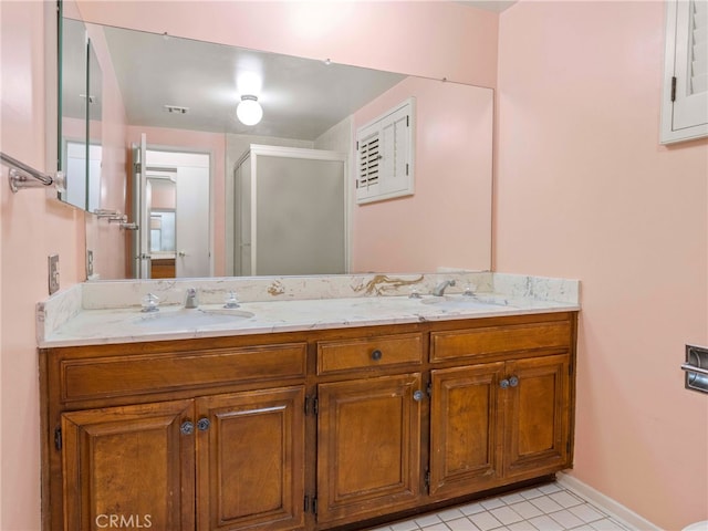 bathroom with tile patterned flooring, vanity, and an enclosed shower